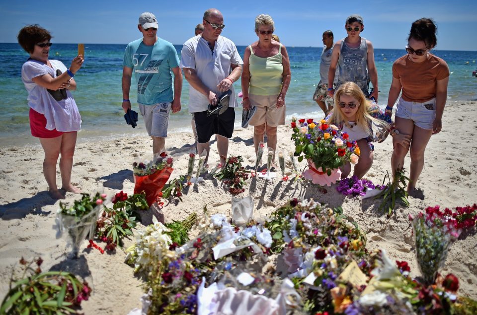 Relatives lay flowers in memory of the 38 holidaymakers murdered in Sousse last year