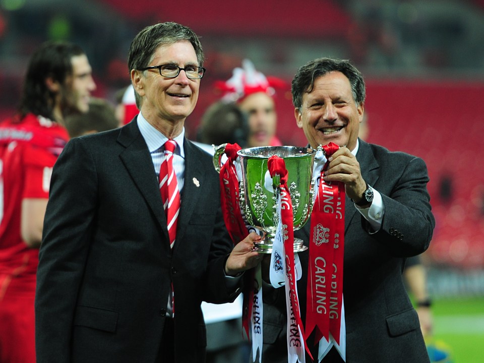  Liverpool owner John W Henry (left) and Chairman Tom Werner (right) pose with the League Cup after the 2-1 extra-time win over Cardiff in 2012