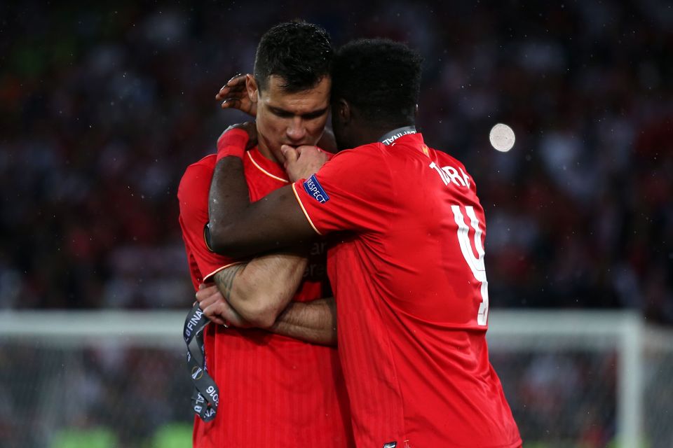  Kolo Toure consoles defensive partner Dejan Lovren after defeat to Sevilla