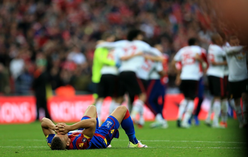 Dwight Gayle lies dejected on the floor after Crystal Palace's FA Cup final defeat by Manchester United