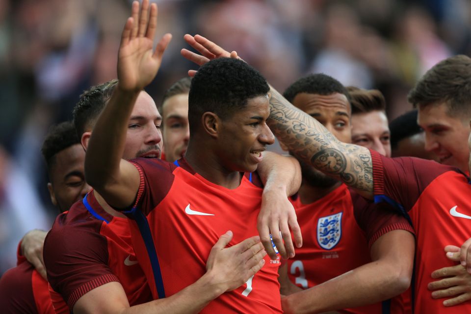  Marcus Rashford celebrates with England team-mates after netting