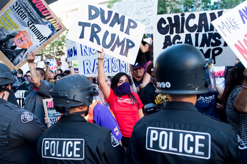  They held signs emblazoned with slogans like 'Dump Trump'