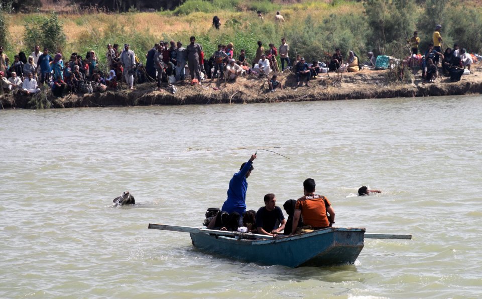  People have been crossing the river on flimsy rafts made out of barrels and old fridges