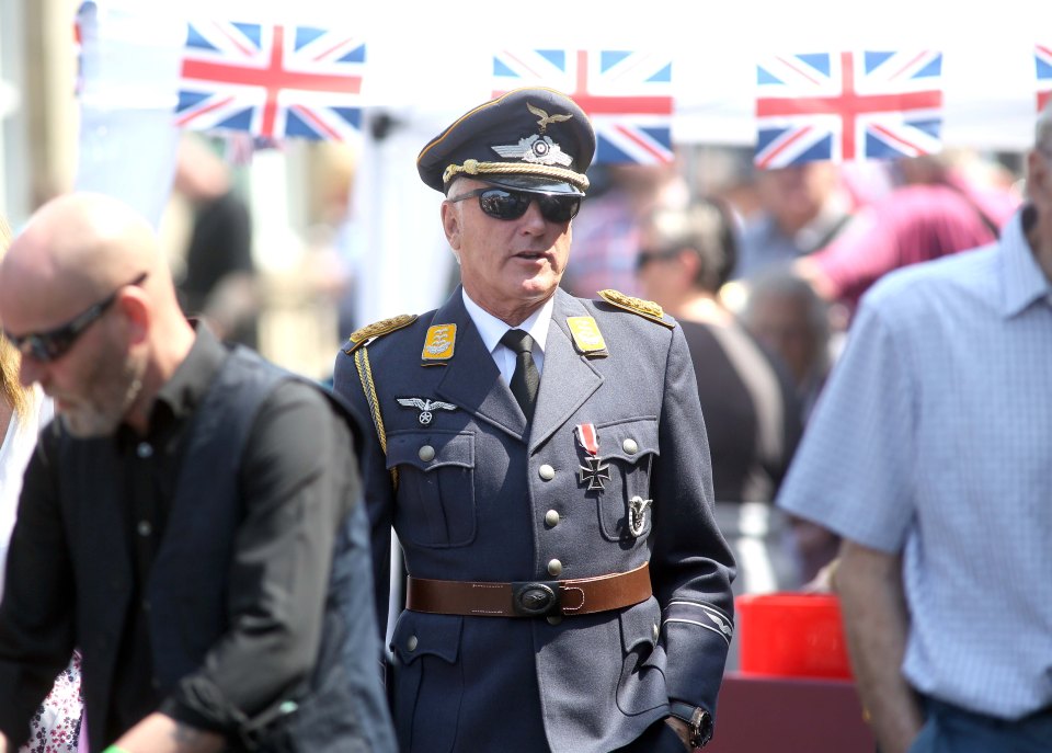 Suited ’n das booted . . . uniformed man in sunglasses 