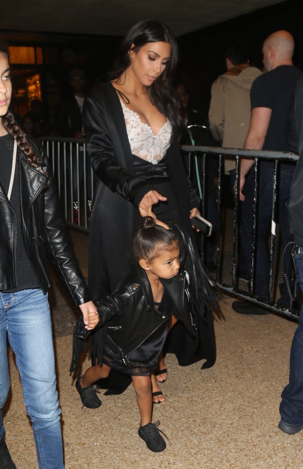  Kim covered up in a long black coat as she led daughter North out of the restaurant