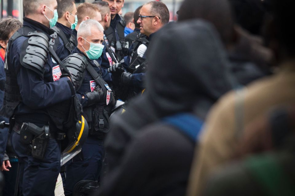 Riot police moved in to clear the gardens of migrants who had made their home in the shanty town