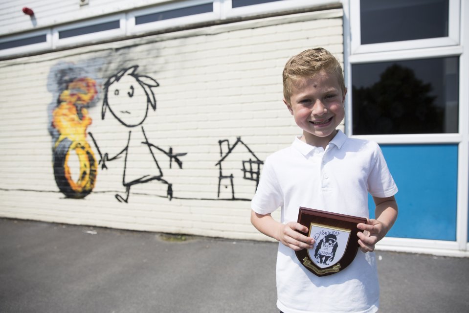  Charlie, 7, holds the plaque with the house named after the famous artist