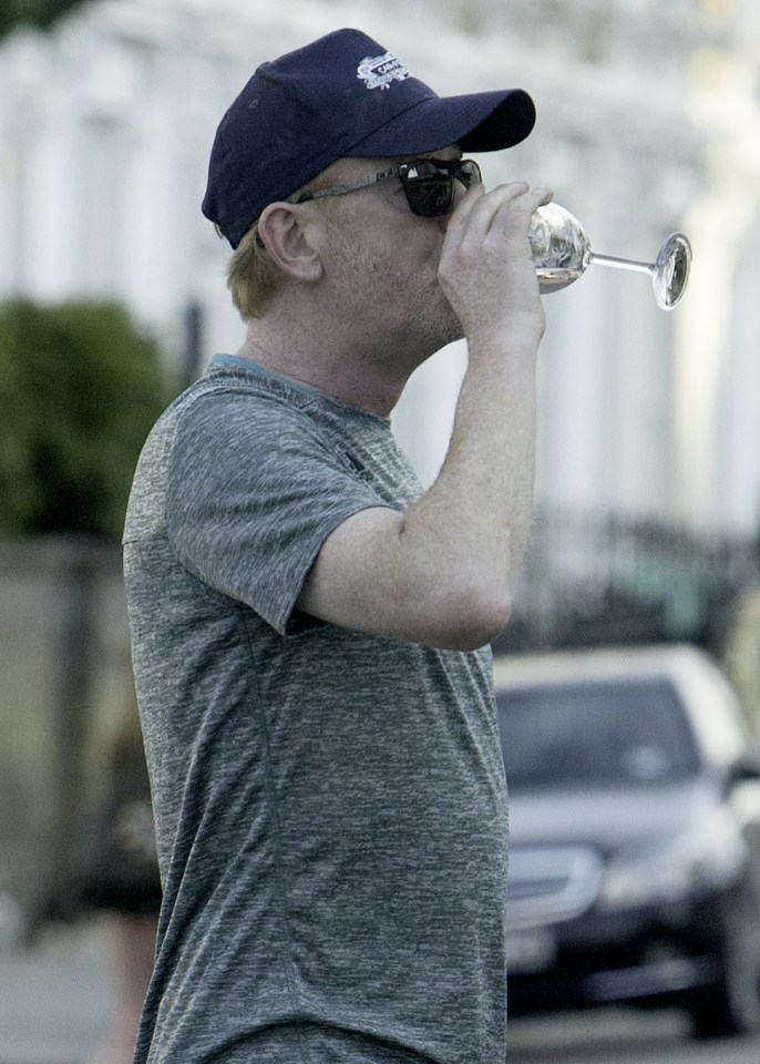 Chris Evans was seen drinking a glass of wine as he walked near his London home