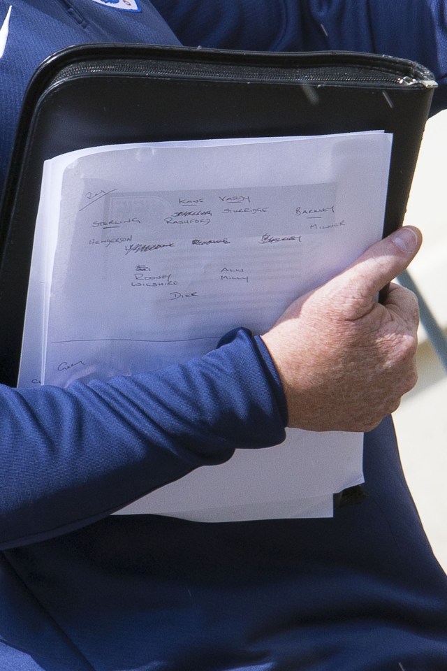  Roy Hodgson's deputy can be seen with notes as he returns to the squad's hotel