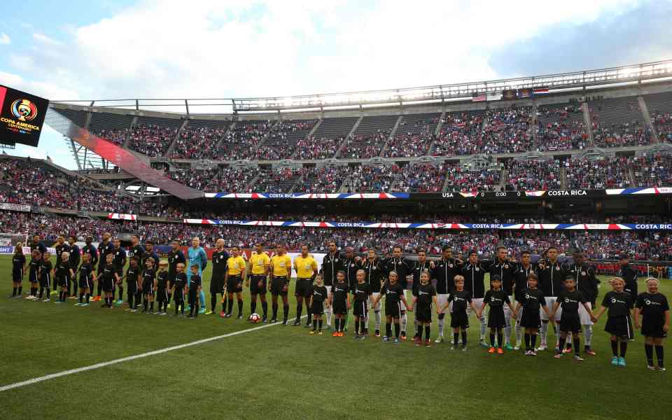 The Costa Rica and USA players players line up before the contest in Chicago