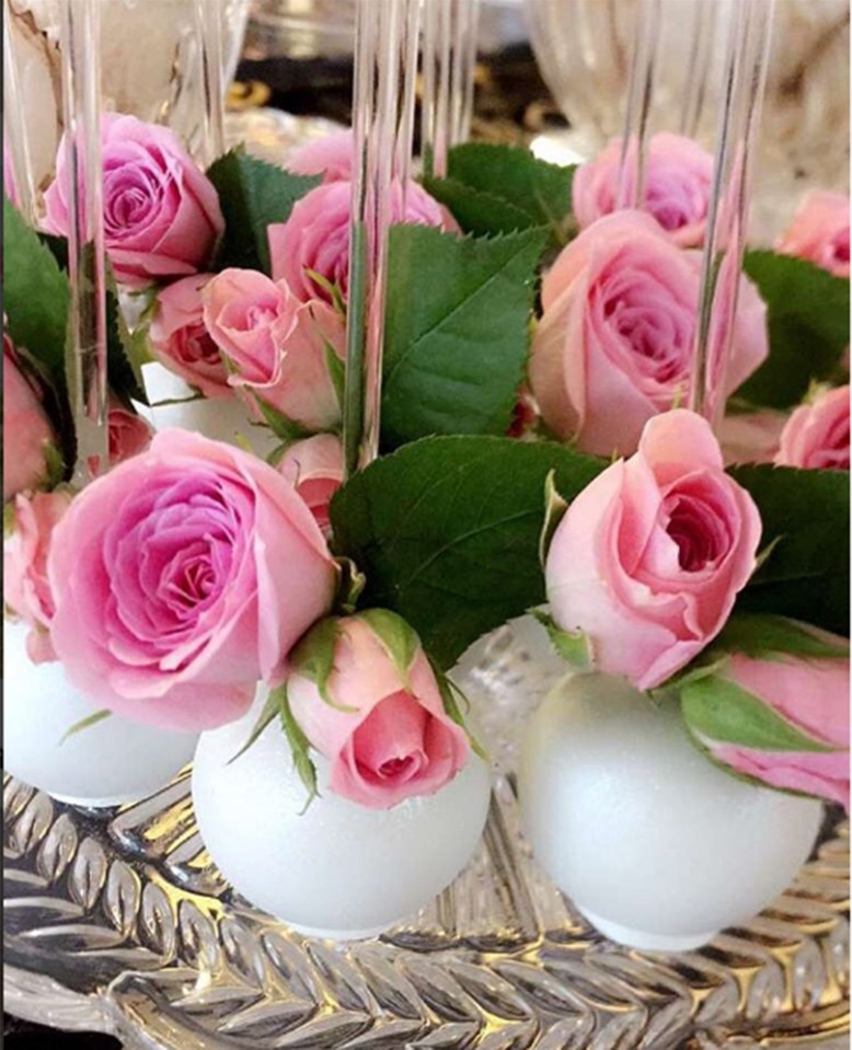  An assortment of pink blooms decorated the opulent party room