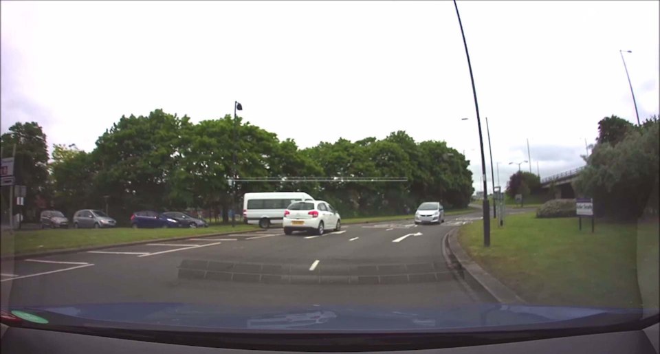 CAR REVERSES AROUND ROUNDABOUT