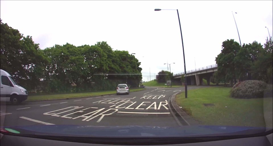 CAR REVERSES AROUND ROUNDABOUT