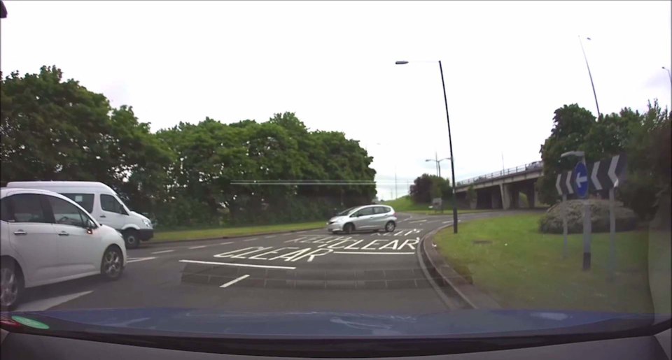 CAR REVERSES AROUND ROUNDABOUT