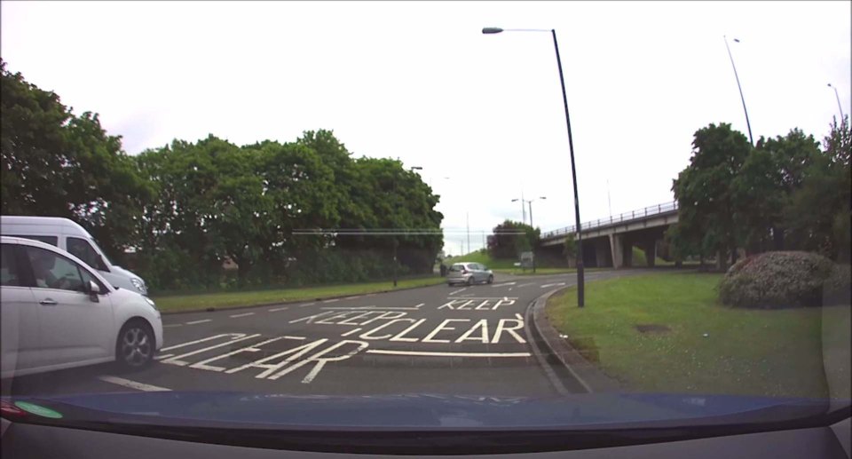 CAR REVERSES AROUND ROUNDABOUT