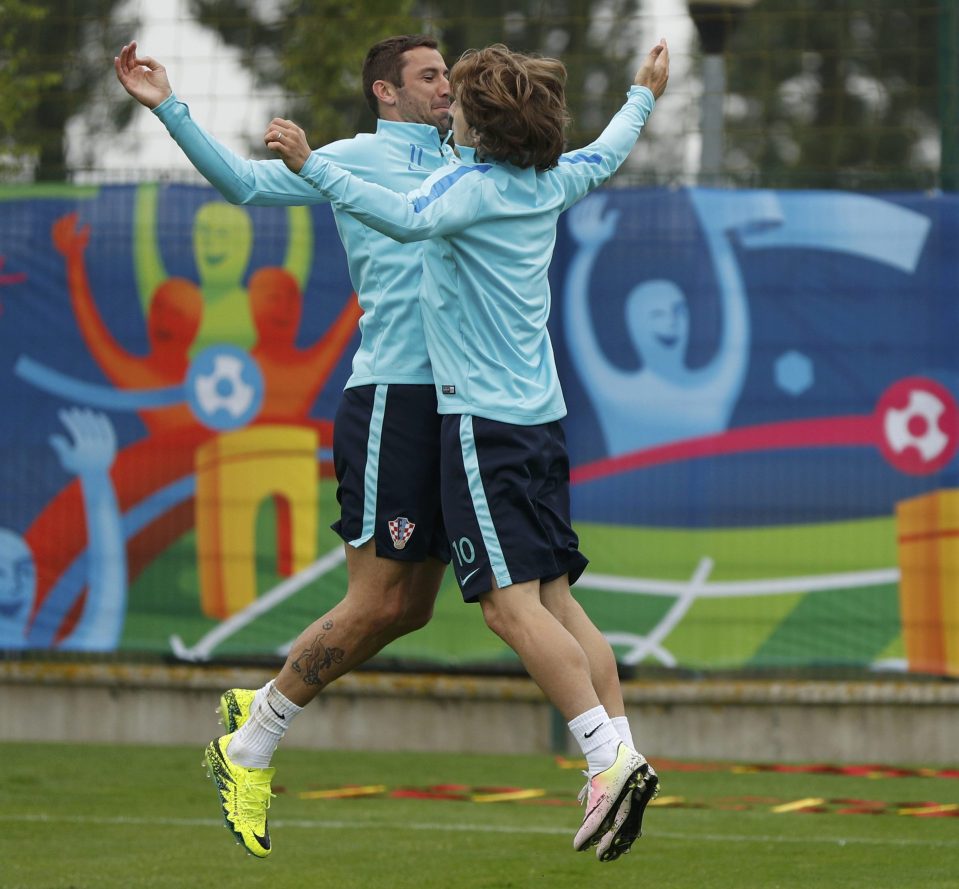  Croatia duo Darijo Srna and Luka Modric body check each other in training