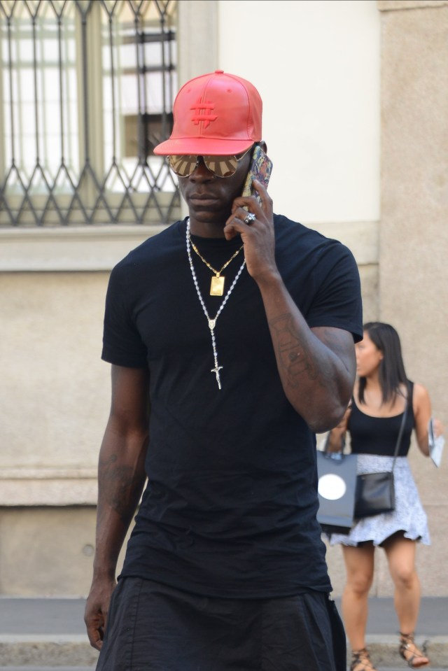  Liverpool striker Mario Balotelli and his brother Enock Barwuah have been out shopping in the Philipp Plein store in downtown Milan while he searches for a club