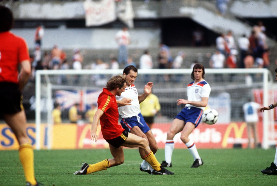 Ray Wilkins is challenged for the ball by Belgium's Walter Meeuws