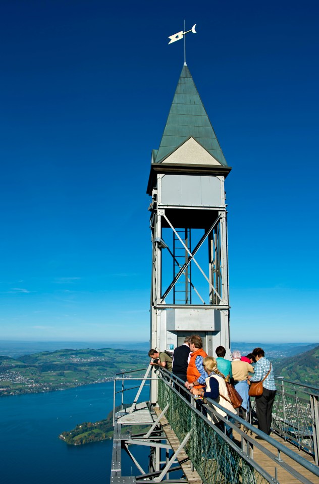  Tourists jet up to the viewing platform in a glass elevator