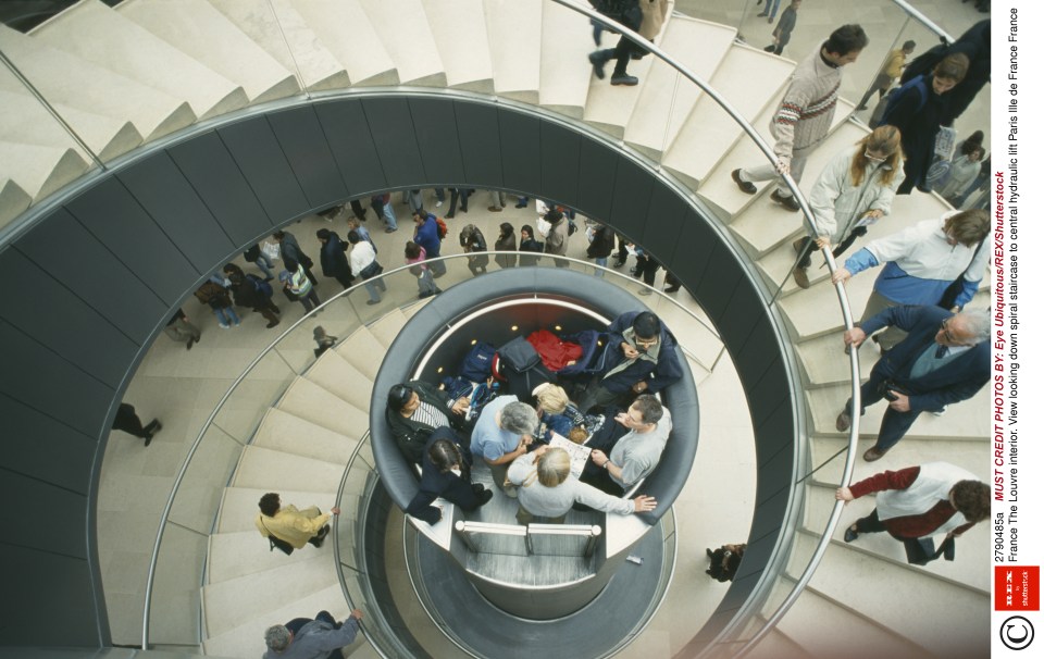  Visitors stand on top of the cylinder and are brought down to the lower levels of the museum