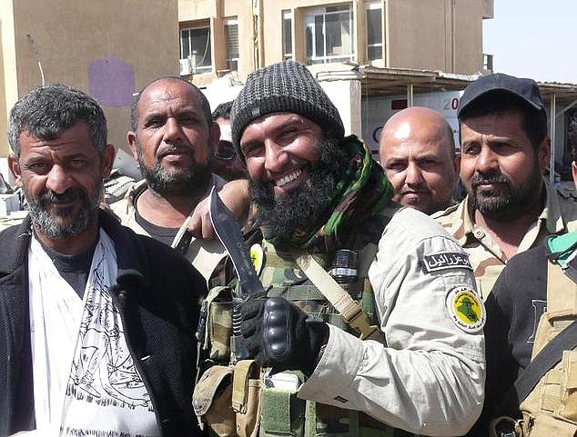  The popular soldier poses for a picture with Iraqi civilians