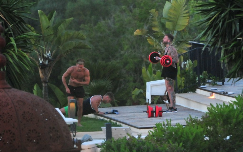  As Aaron takes on the bar bells, Scotty does push ups on the decking