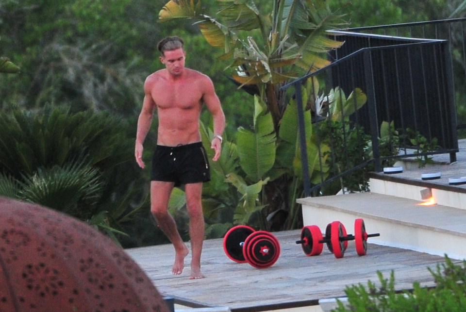  Hunky Gaz looks like he's caught the sun a bit too much and appears red raw as he flaunts his six-pack abs