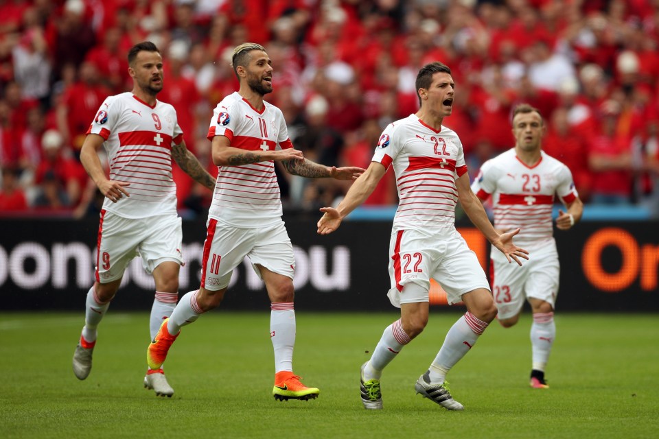  Schar wheels away in delight after netting from Xherdan Shaqiri's corner