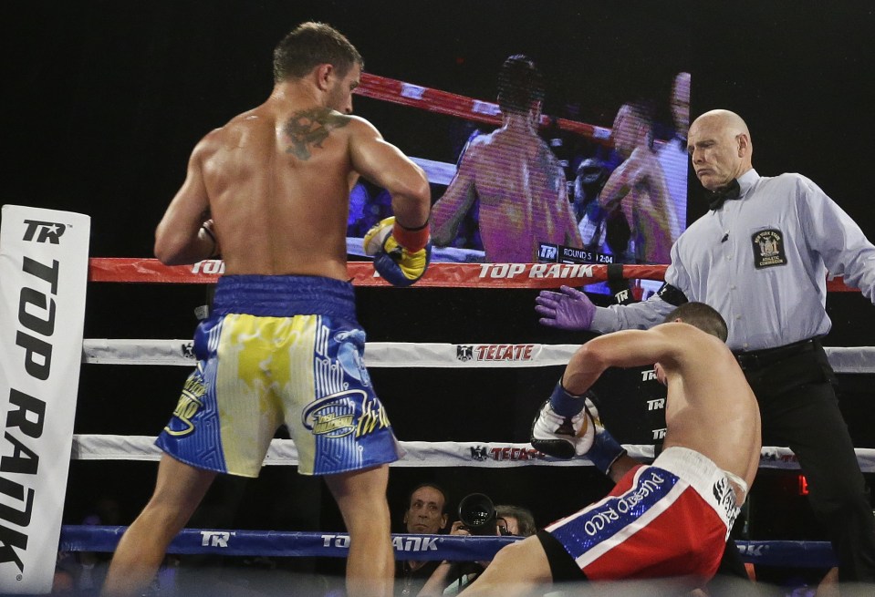 Vasyl Lomacheko connects with a right hook to floor Roman Martinez