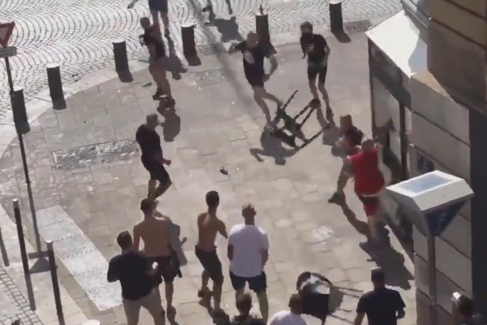  The unidentified man in the red t-shirt rushes ahead and starts throwing punches and kicks