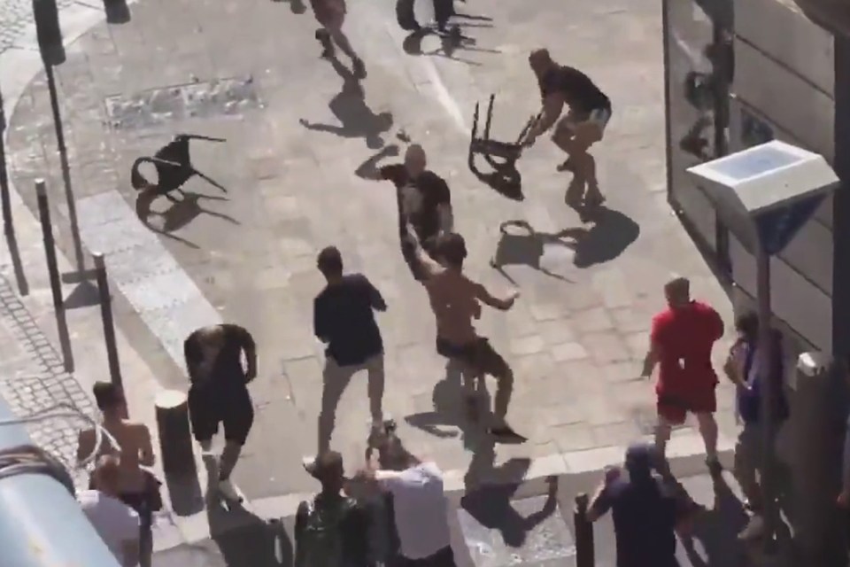  At the start of the video, England fans advance towards the Russian supporters and start throwing chairs