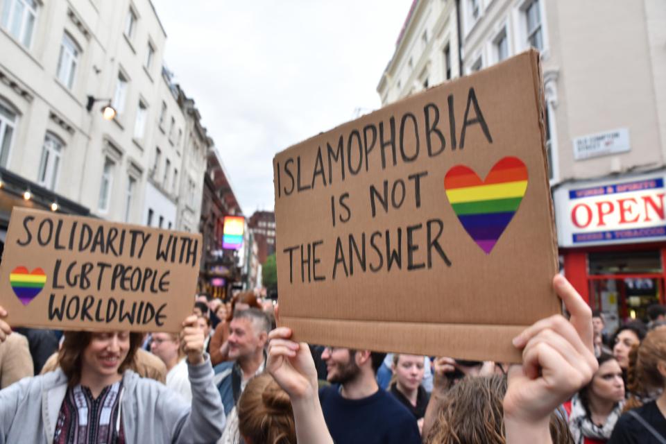  Mourners held signs reading "homophobia is not the answer" in Soho