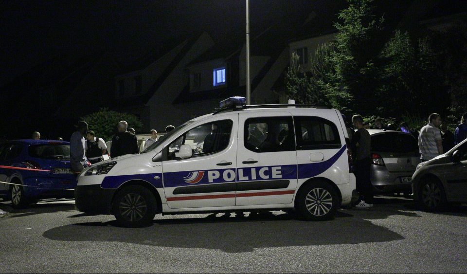 Police vehicle blocks the road during the raid