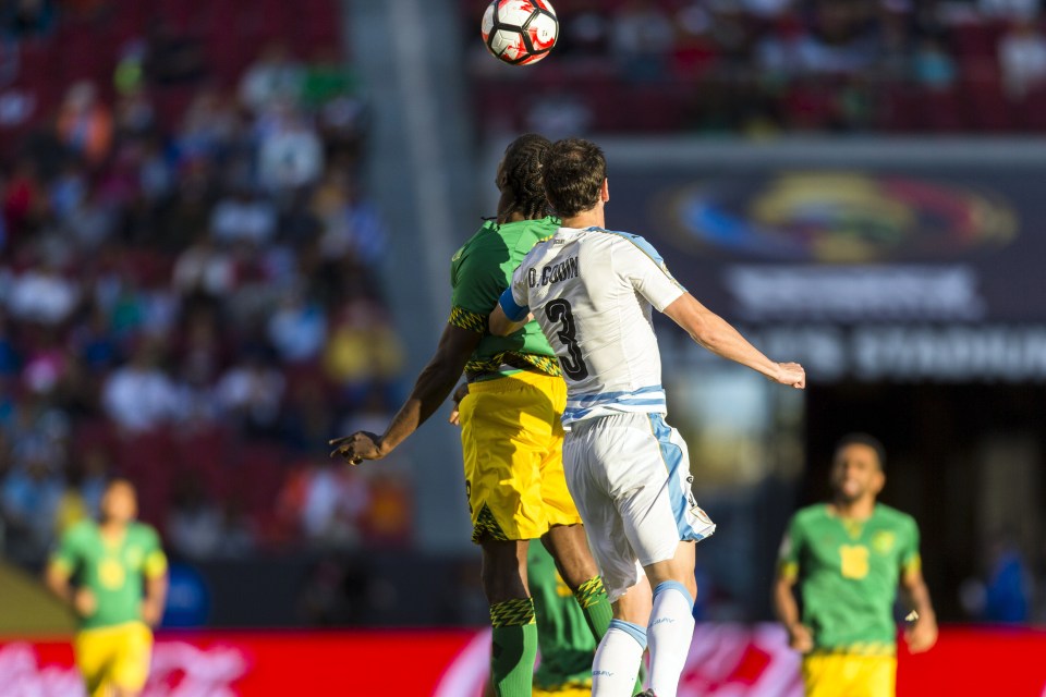 Diego Godin challenges for the ball on the night he won his 100th Uruguay cap