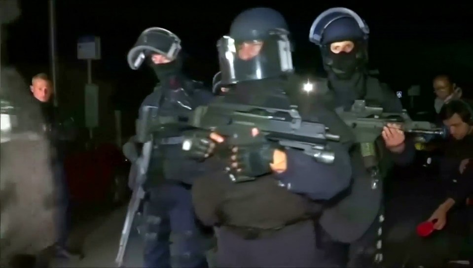 Police arrive at the scene where a French police commander was stabbed to death in front of his home in the Paris suburb of Magnanville