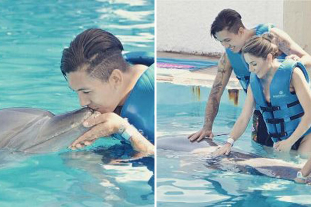 Roberto Firmino and wife Larissa Pereira swim with dolphins in Cancun, Mexico