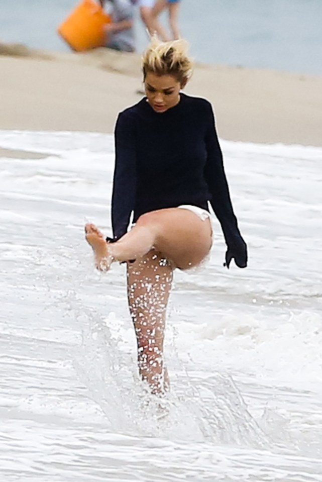  Splash good time... Rita Ora has fun as she messes around during beach photo shoot