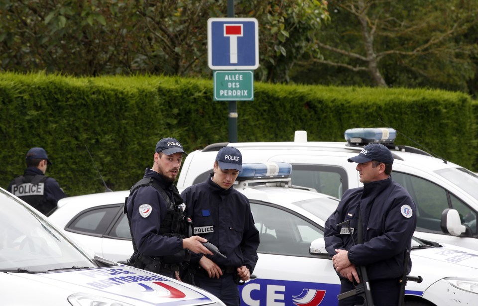 French police officers block the road leading 