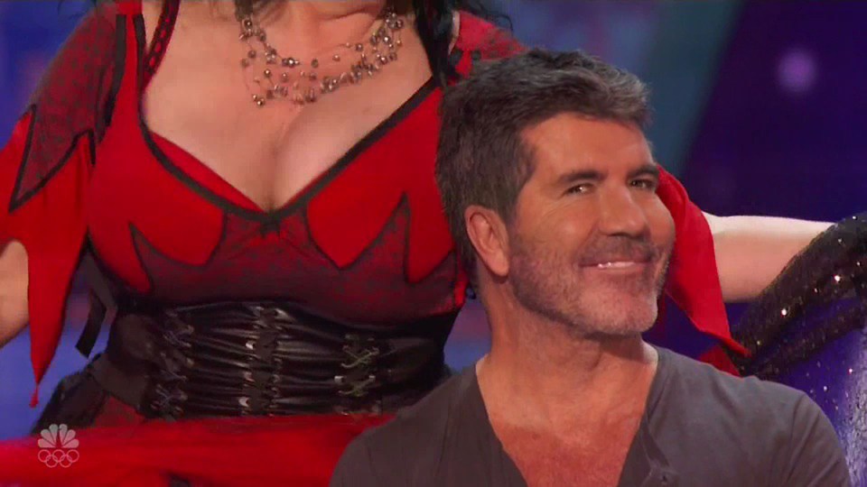  Simon grins as Miranda dances around him