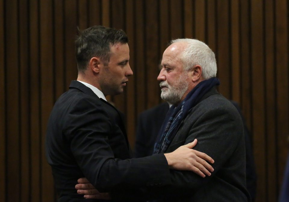  Oscar Pistorius embraces his father Henke Pistorius in Pretoria High Court