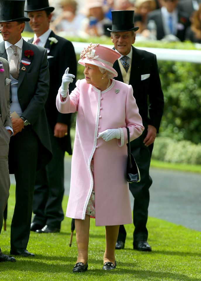  The Queen, flanked by the Duke of Edinburgh, was keen to get on with the day of racing as she walked towards the Royal box