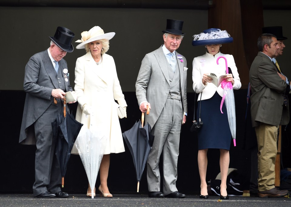  The Duchess of Cornwall and the Prince of Wales are ready for the rain to pour, as they both have outfit matching umbrellas for the day