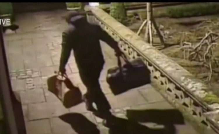  The men are seen leaving with bags full of money and high value items