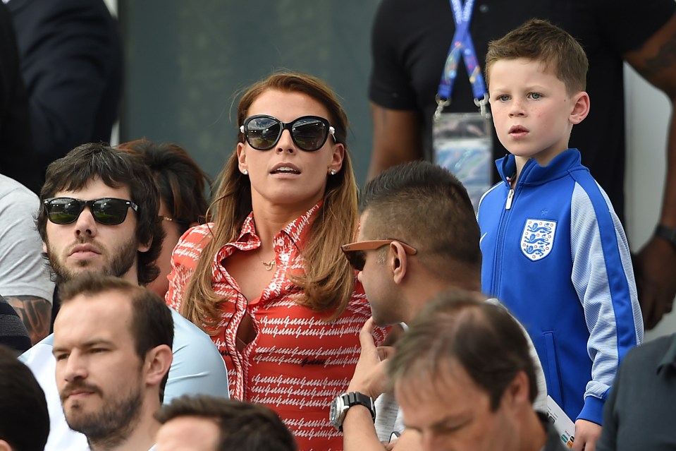  Coleen looks pensive during the 2-1 victory alongside her lad Kai - dressed in an England tracksuit