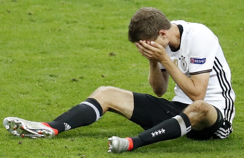 Germany's Thomas Muller holds his face