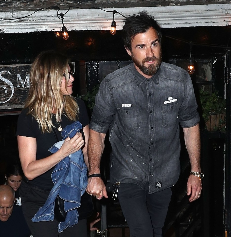 She also concealed her stomach when she went out for dinner with husband Justin Theroux