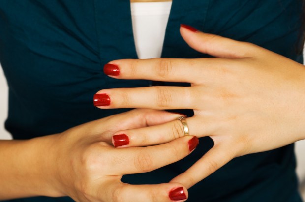 Woman taking off wedding ring