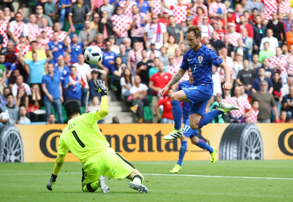 Ivan Rakitic of Croatia chips Petr Cech