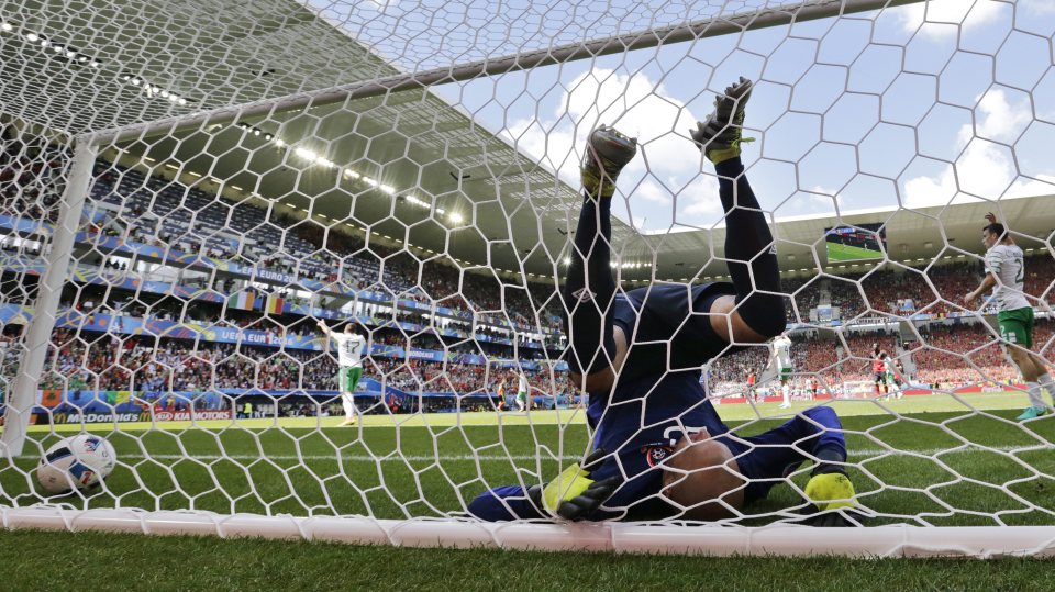 Darren Randolph clears the ball only to end up tangled in his net