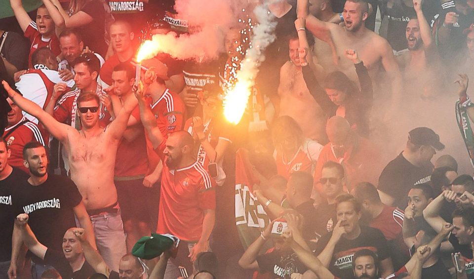 Hungary supporters are pictured holding flares in the stands in Marseille